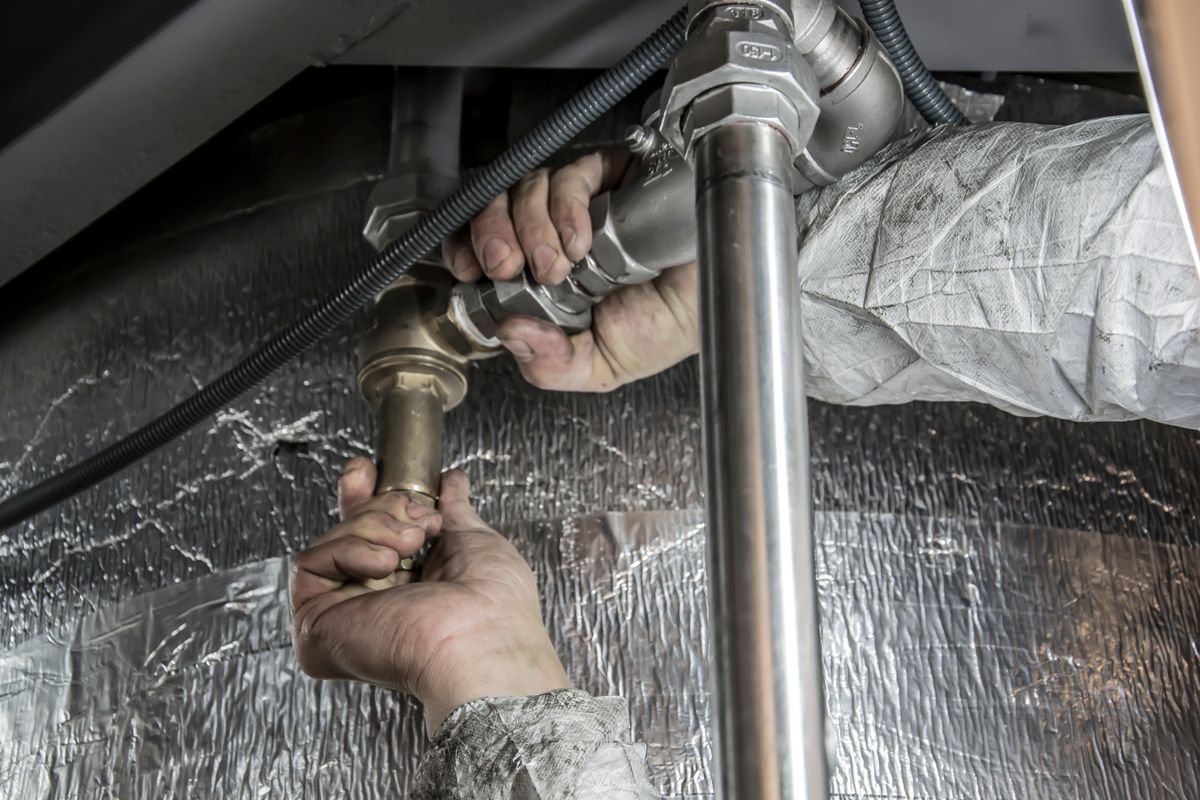 Professional pipe fitting installation as part of central heating upgrade in Stockport